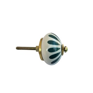 May include: A white and teal ceramic cabinet knob with a brass base and screw. The knob features a teal petal design. The hardware is designed for use on drawers, cabinets, and furniture.