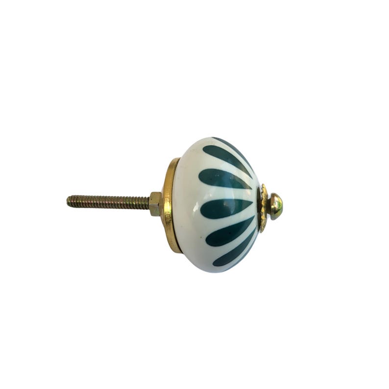 May include: A white and teal ceramic cabinet knob with a brass base and screw. The knob features a teal petal design. The hardware is designed for use on drawers, cabinets, and furniture.
