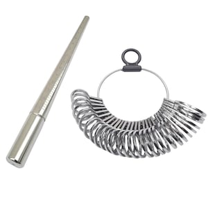 May include: A silver ring sizer tool and a set of silver ring size gauges. The ring sizer is a tapered metal rod with measurement markings. The ring gauges are attached to a metal ring with a black handle.