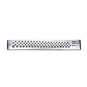 May include: A rectangular, silver-colored metal object with numerous circular perforations. The number "32" is visible on the left end. The text "SHEM MON POLY" is printed on the right end. The object is likely a tool or component.