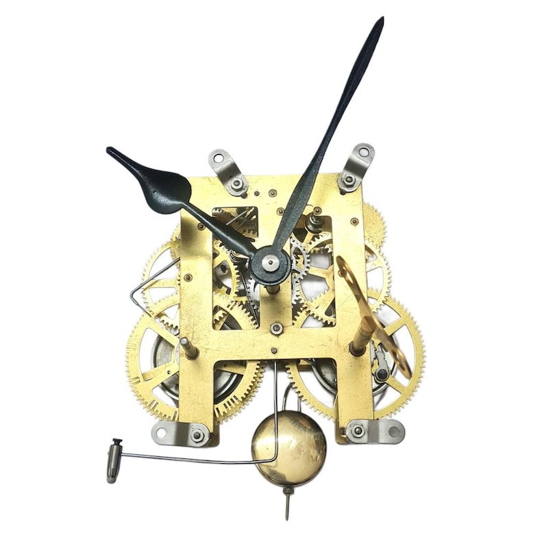 May include: A clock mechanism featuring brass gears, a pendulum, and black clock hands. The clock's face is a brass-coloured square with multiple gears visible. The hands are black, and the pendulum is a gold-coloured sphere.