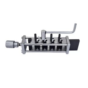 May include: A silver metal tool with a handle and a series of black metal pins. The tool is used for making holes in leather or other materials.