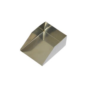May include: A metallic, gold-toned scoop with a wide, open front and high, angled side walls. The object features a smooth, reflective surface and a flat base, designed with a deep, rectangular basin for collecting or transferring dry goods.