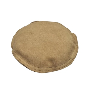 May include: A brown suede hat with a rounded shape and a stitched edge.