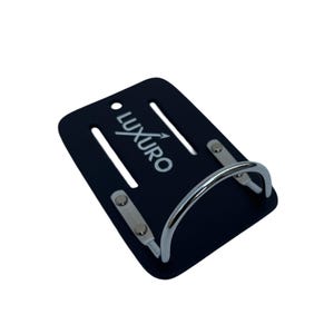 May include: A black phone grip with the word "LUXURO" in white. The grip has a silver metal handle and silver metal accents. The grip has two slots and a hole at the top.