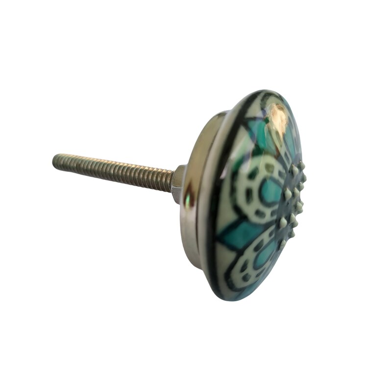 May include: A decorative cabinet knob with a silver base and a ceramic face. The ceramic face features a teal and white floral design. The knob has a threaded post for easy installation. Ideal for adding a touch of elegance to furniture.