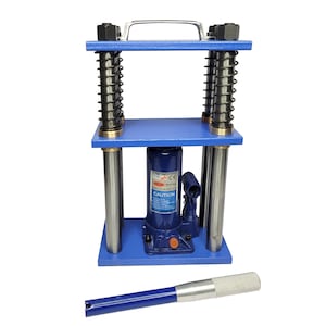 May include: A blue hydraulic press with a silver handle and springs. The press has a blue base and top, with silver support rods. A silver and blue tool is in the foreground. The press has a "CAUTION" label.
