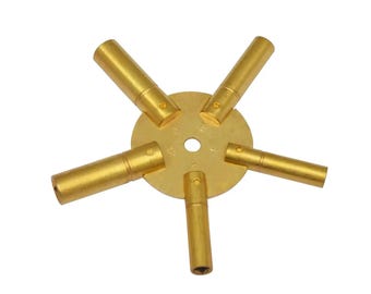 May include: A gold-colored key winders set with five different sized keys. The keys are attached to a round metal base.