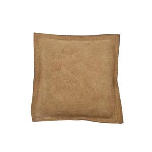 May include: A tan suede pillow with a stitched border.