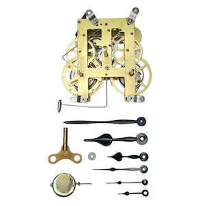 May include: Clock mechanism components, featuring a brass frame with gears, a key, and black clock hands. The parts are displayed against a white backdrop, highlighting the intricate details of the clock mechanism.