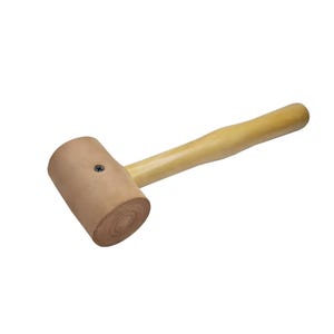 May include: A wooden mallet with a brown leather head. The head is attached to the wooden handle with a screw.