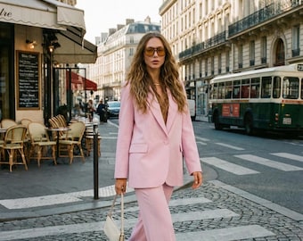 May include: A white ceramic mug with a black handle and the text "But First, Coffee" in a bold, black font. The mug is set against a neutral background, highlighting its simple design.