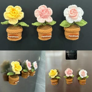 May include: Crocheted flower magnets in yellow, pink, and white, each in a brown pot with green leaves. The word "Handmade" is on each pot. The magnets are displayed on a refrigerator.