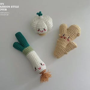 May include: Crocheted food set featuring a white garlic bulb, a beige ginger root, and a green and white scallion. Each item has a smiling face. The text "CITY FASHION STYLE LOVER" is in the upper left corner.