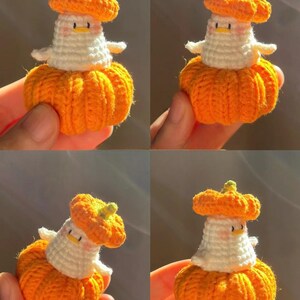 May include: A handmade crochet pumpkin-themed figurine. The figurine features an orange pumpkin base, a white body, and an orange hat. The face has small black eyes and a yellow beak. The arms are white and outstretched. The figurine is a whimsical fall decoration.