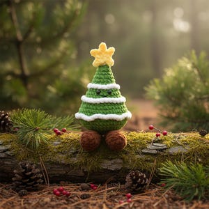 May include: A crocheted Christmas tree with a yellow star on top. The green tree has white trim and brown feet. The tree is sitting on a moss-covered log in a forest setting.