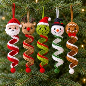 May include: Five crochet Christmas ornaments featuring a Santa Claus, a reindeer, a green character with a red hat, a snowman with a black top hat, and a gingerbread person. Each ornament has a round head and a long, spiraling, multi-colored tail.