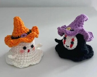 May include: Two handmade crochet Halloween figures. One is a white ghost wearing an orange hat with a black band. The other is a black figure with a purple hat and a white face with red markings. Both have cute, friendly expressions.