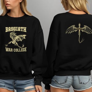 May include: Black sweatshirt with a yellow dragon graphic on the front and back. The front graphic says "Basgiath War College".