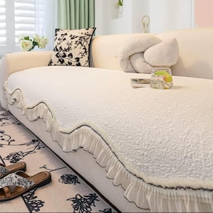 May include: A set of three ceramic vases in varying heights and shapes. The vases feature a matte white finish and a minimalist design, suitable for displaying flowers or as decorative objects. The tallest vase is approximately 10 inches high.