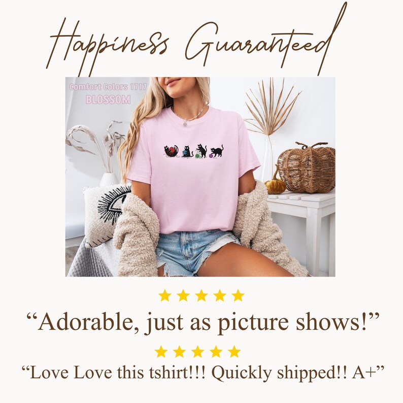 May include: A light pink t-shirt with a graphic of black cats playing with yarn balls. The shirt has the text "Comfort Colors 1717 BLOSSOM" printed on it. The words "Happiness Guaranteed" are written in cursive at the top.