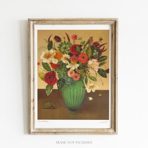 May include: Framed art print featuring a vibrant floral arrangement in a green vase. The bouquet includes red roses, white daisies, and succulents. A small turtle is depicted near the vase. The print is in a gold-colored frame. The text "Flora and Fauna" is visible.