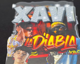 May include: Black t-shirt with a graphic print of three men. The print features the text "Xavi" in large, glittery letters and "La'Diablo" in red and yellow letters. The text "Answer to No Xavi" is also visible in the print.