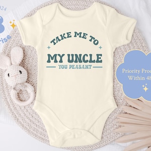 May include: A white baby onesie with a blue graphic that says "Take me to my uncle - you peasant".