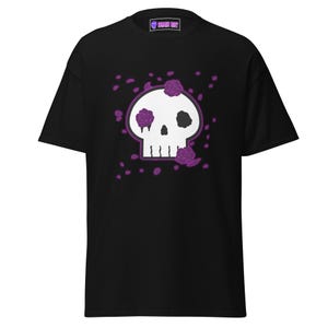 May include: Black t-shirt with a white skull graphic and purple roses. The skull has one eye and a dripping tear. The text "SKULL BOY" is on the tag.