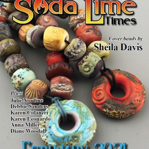 May include: A magazine cover featuring a colourful beaded necklace with a large, blue and green, glazed ceramic bead. The magazine is titled "Soda Lime Times" and the cover reads "Cover beads by Sheila Davis" and "February 2021".