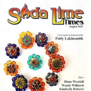 May include: The cover of "Soda Lime Times" magazine, August 2019, features colorful flower-shaped beads. The beads are in shades of orange, yellow, blue, and green. The magazine title and the words "BUTTONS & HEADPINS" are also visible.