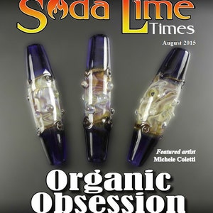 May include: Three glass beads with a blue and white swirl pattern. The beads are featured in a magazine called "Soda Lime Times" with the text "Organic Obsession" and "Featured artist Michele Coletti".