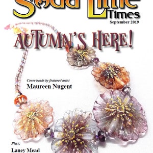 May include: A necklace with glass flower beads in shades of pink, purple, and orange with gold accents. The beads are strung on a silver chain with purple and clear beads. The necklace is on a white background. The text "Soda Lime Times" and "Autumn's Here!" is at the top of the image. The text "Cover beads by featured artist Maureen Nugent" is in the middle of the image. The text "Plus: Laney Mead Lee Woodburn Debbie Sanders" is at the bottom of the image.