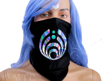 May include: Black face mask with a holographic silver and teal design of a stylized circle with concentric rings. The design is reminiscent of a music festival logo.