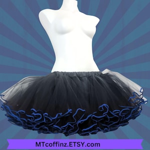May include: Black tulle petticoat with a blue ruffled trim. The petticoat is shown on a white mannequin.