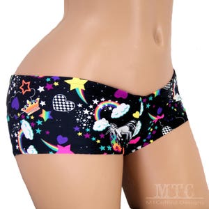 May include: Black underwear with a colourful print of stars, rainbows, hearts, and a unicorn. The print also includes a crown and chequered pattern.