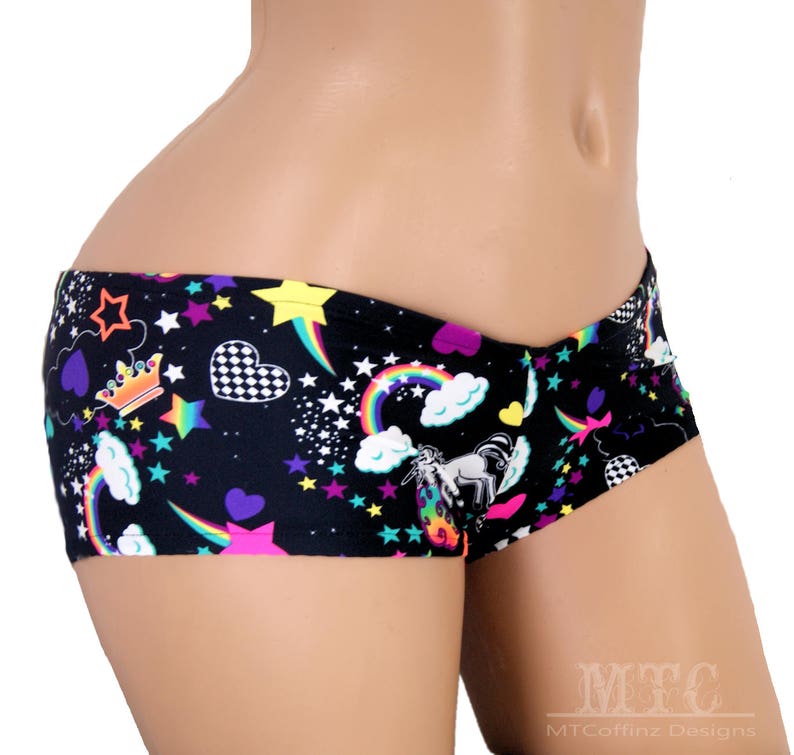 May include: Black underwear with a colourful print of stars, rainbows, hearts, and a unicorn. The print also includes a crown and chequered pattern.