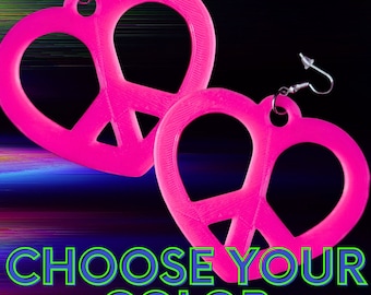 May include: A pair of pink peace sign earrings in the shape of a heart. The earrings are made of plastic and have silver hooks. The text "CHOOSE YOUR COLOR" is displayed below the earrings.