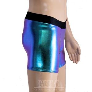 May include: A pair of iridescent blue and green shorts with a black waistband. The shorts are made of a shiny, metallic fabric.