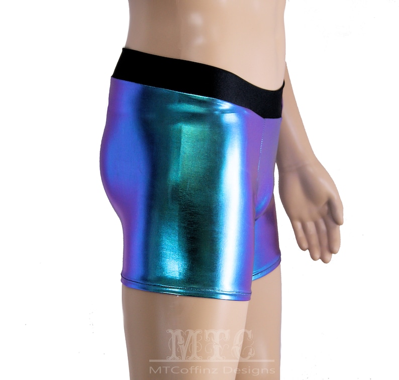 May include: A pair of iridescent blue and green shorts with a black waistband. The shorts are made of a shiny, metallic fabric.