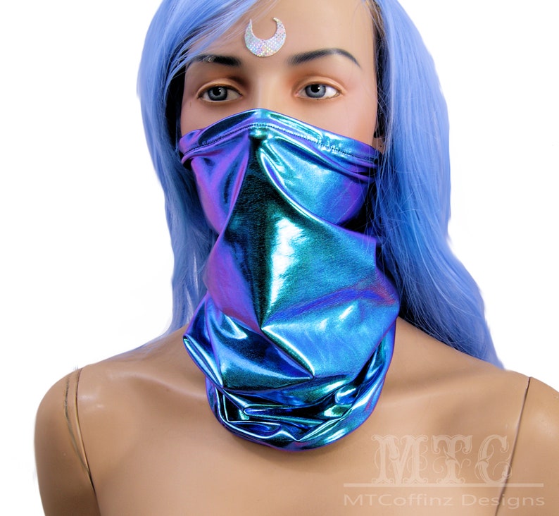 May include: A blue iridescent face mask with a shiny, metallic finish. The mask is made of a soft, stretchy fabric and is designed to cover the nose and mouth.