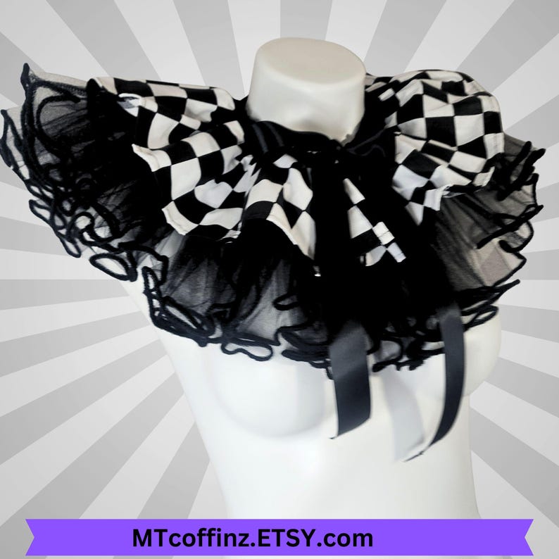May include: A black and white chequered collar with a ruffled tulle trim and satin ribbon ties. The collar is displayed on a white mannequin bust. The text "MTcoffinz.ETSY.com" is at the bottom of the image.