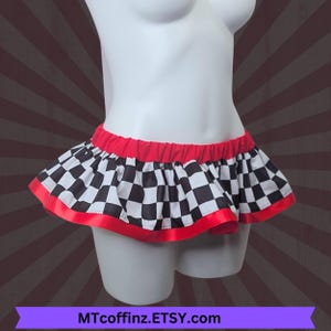 May include: A ruffled mini skirt with a black and white checkered pattern, red waistband, and red trim. The skirt is displayed on a white mannequin. The Etsy shop name MTcoffinz.ETSY.com is visible at the bottom.