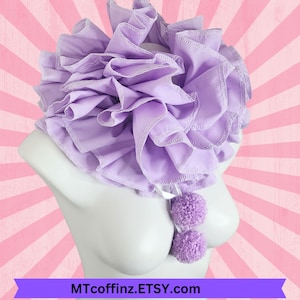 May include: A lavender ruffled collar with two matching pom-poms, displayed on a white mannequin bust. The collar features multiple layers of fabric with a decorative edge. The Etsy shop name MTcoffinz.ETSY.com is displayed at the bottom.