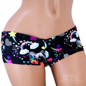 May include: Black and white short shorts with a colourful unicorn, rainbow, and star print.