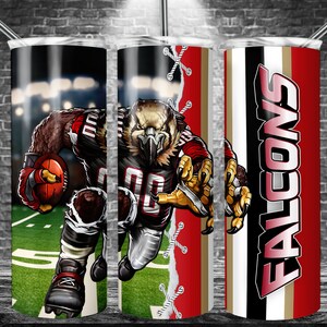 May include: A set of three stainless steel tumblers with a red, black, and gold design. The tumblers feature a cartoon image of a football player wearing a red and black uniform with the word "FALCONS" on the side.