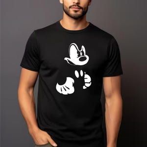May include: A black t-shirt with a white graphic of Mickey Mouse's head and hands.