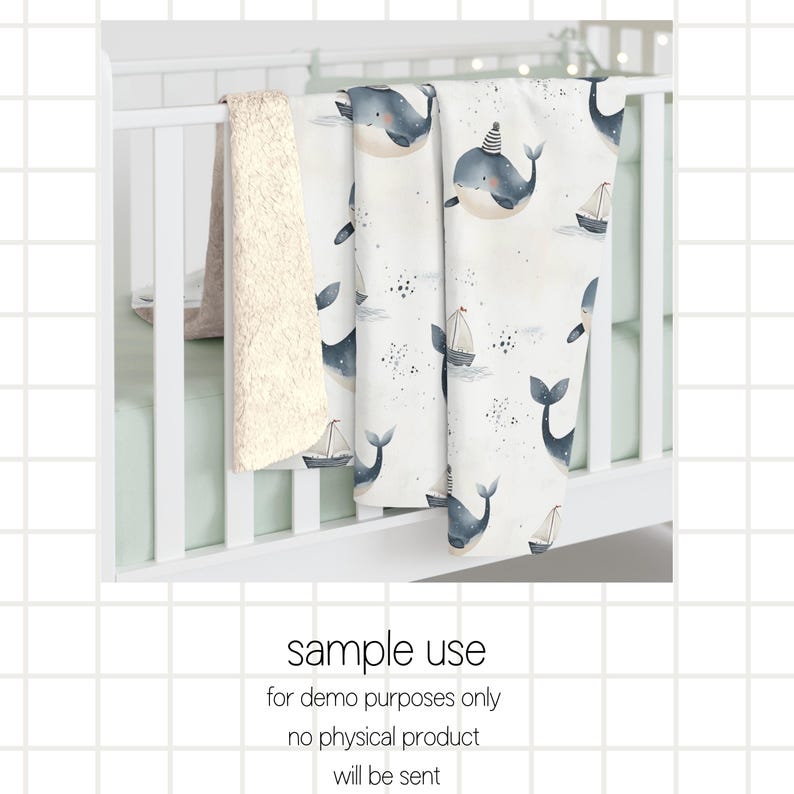 May include: A white crib sheet with a blue whale pattern. The sheet features a variety of whales with different poses and a few small sailboats. The sheet is on a white crib.
