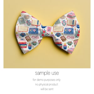 May include: A white fabric bow tie with a repeating pattern of books, teacups, candles, and floral elements. The bow tie is on a yellow background. The text "sample use" is at the bottom of the image.