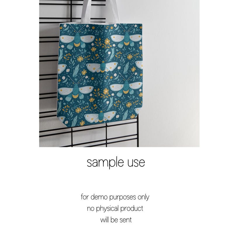 May include: A blue tote bag with a white handle and a pattern of white moths and yellow flowers on a dark blue background.